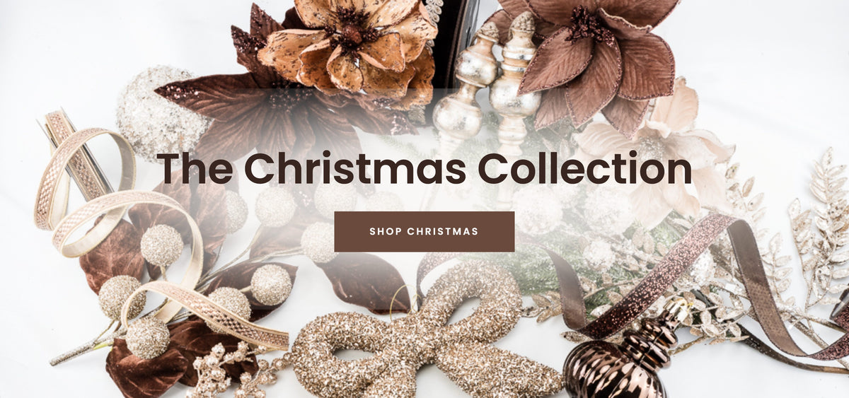 The Christmas Collection banner in bronze and brown with a shop Christmas call to action button
