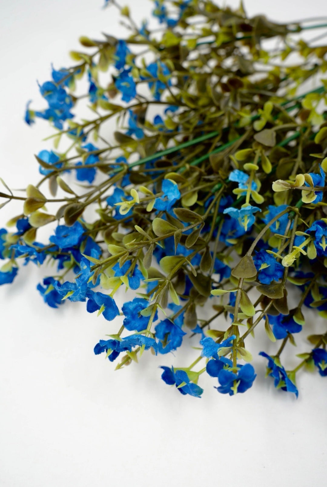 Blue filler flowers and boxwood greenery
