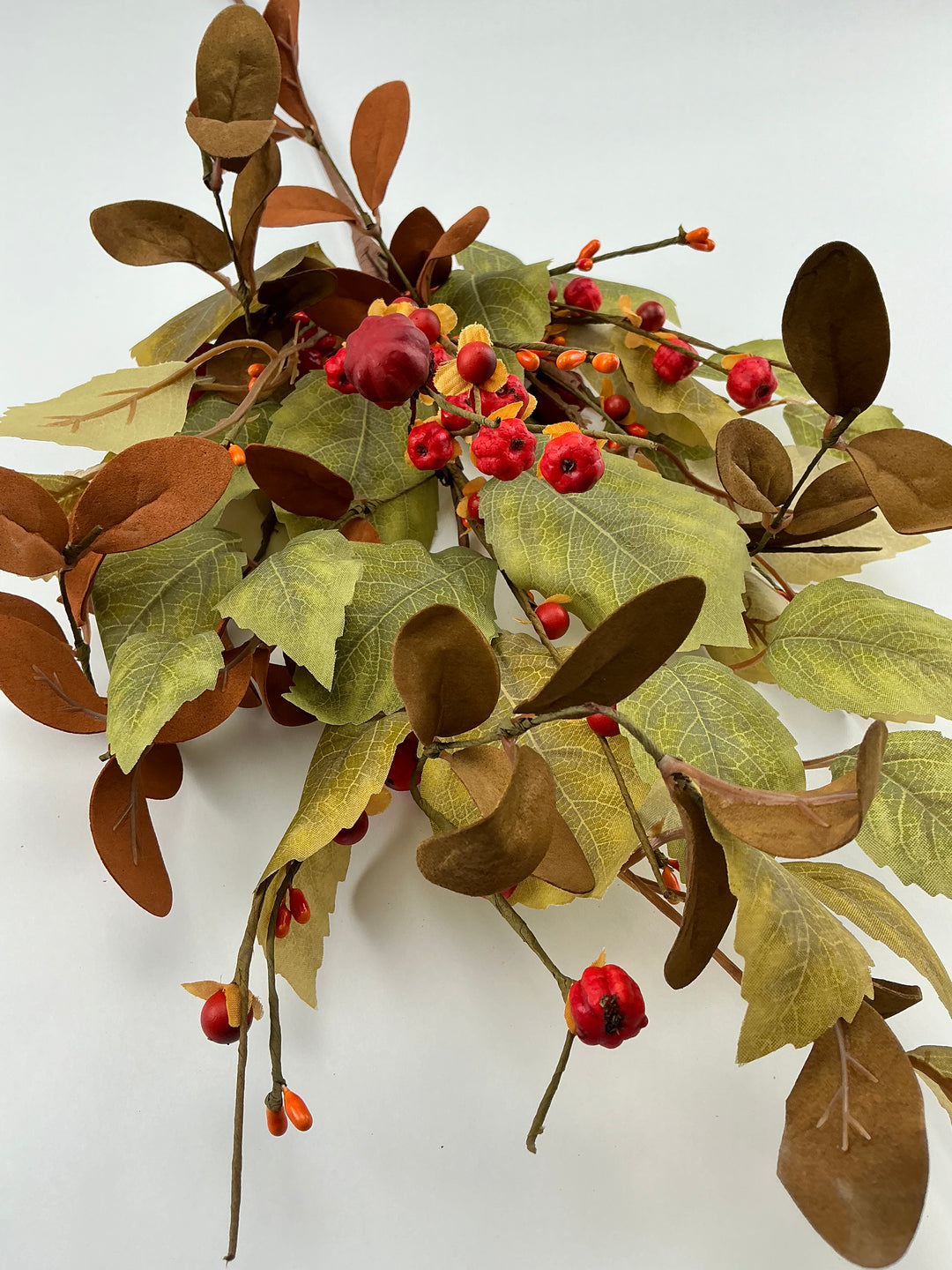 Mini pumpkins, rose leaves and bittersweet spray