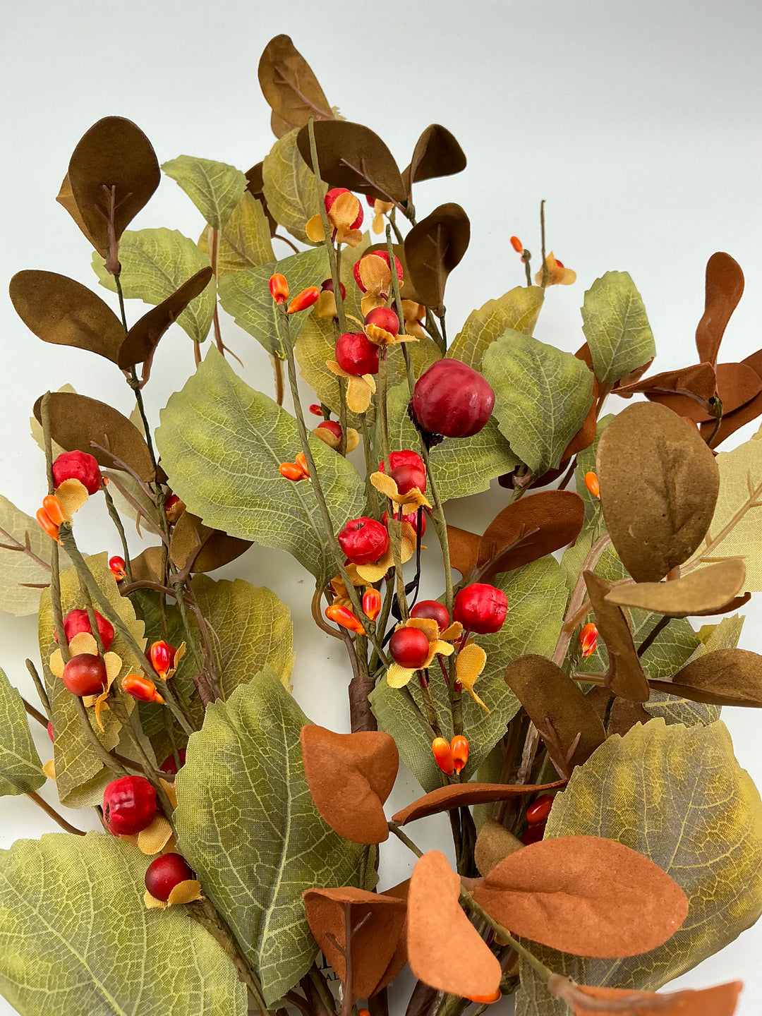 Mini pumpkins, rose leaves and bittersweet spray