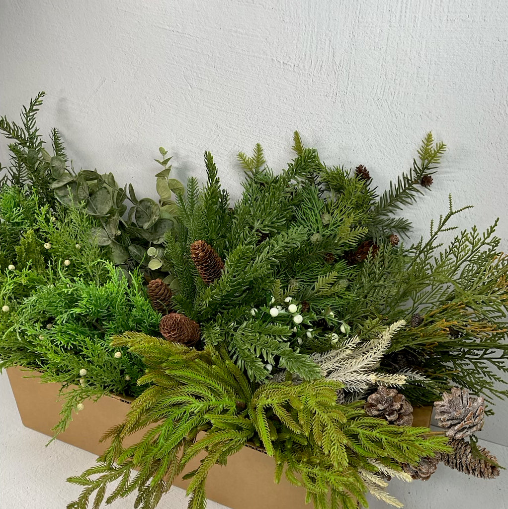 Warm green winter greenery and cones box