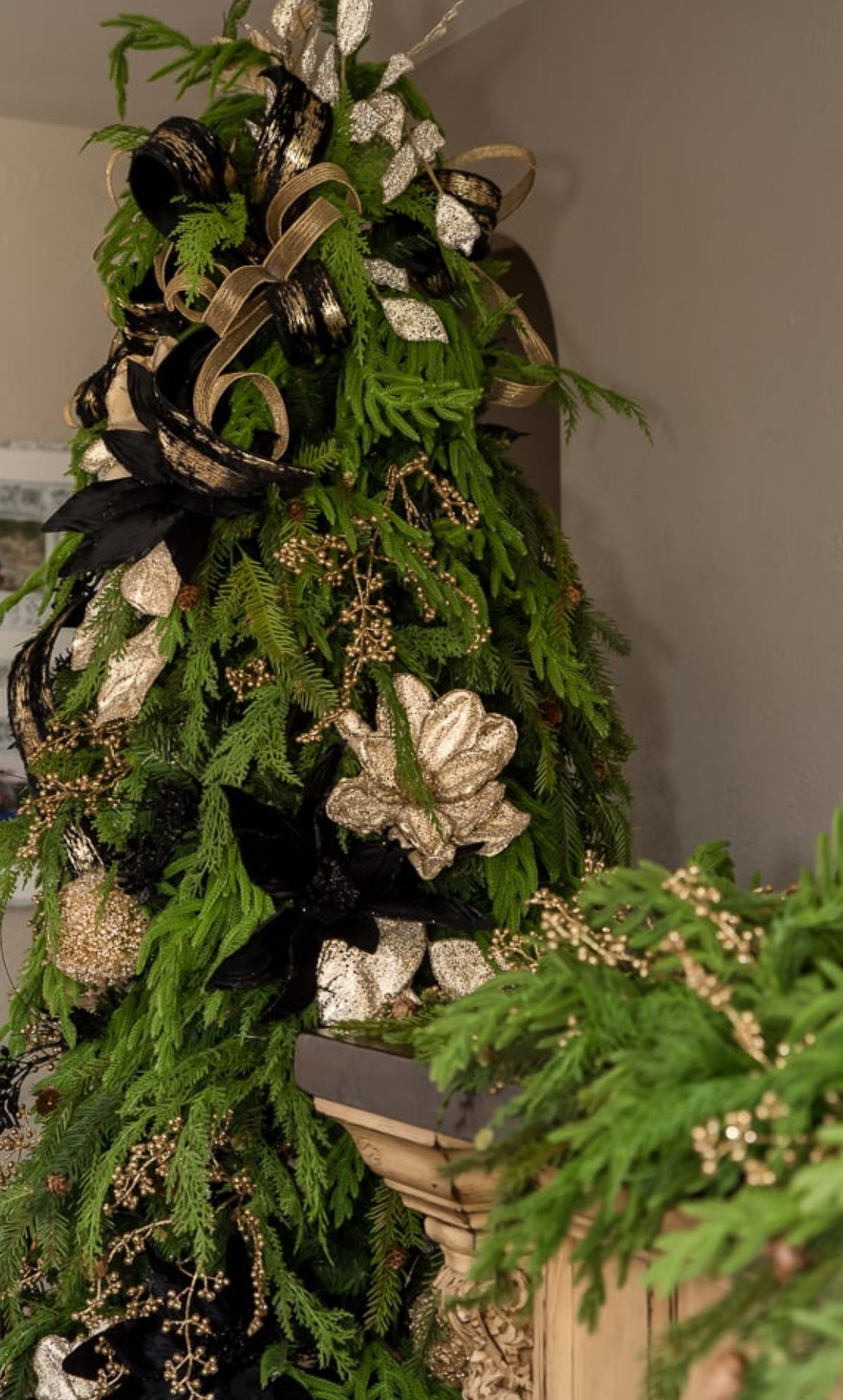 Green Christmas tree with gold bows and ornaments