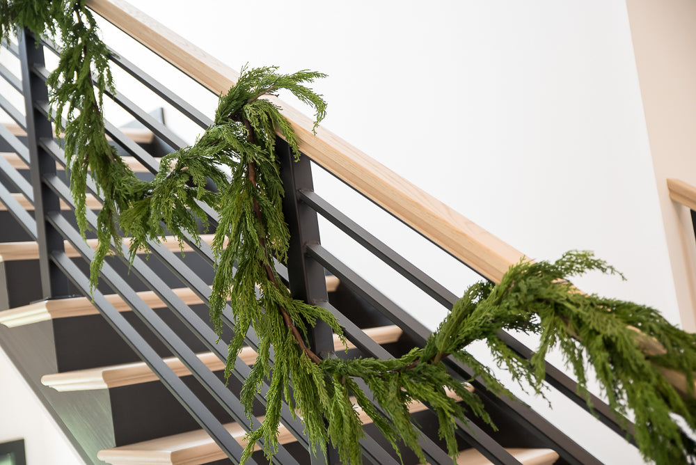 green garland draped on stairwell