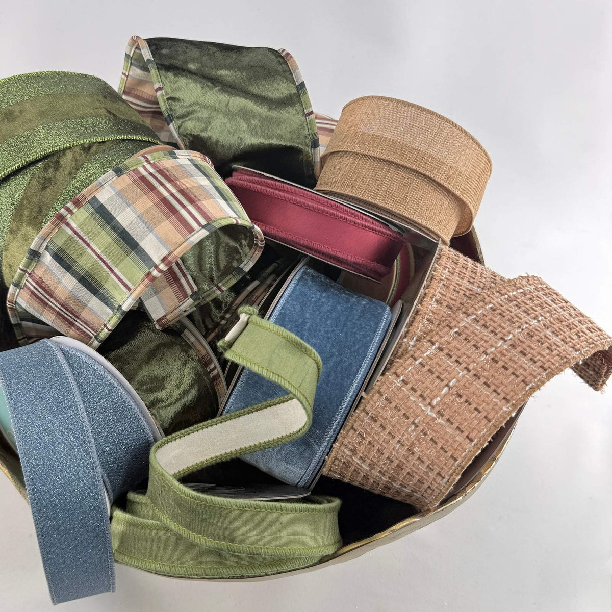 bowl of plaid, green, brown, blue, and tweed ribbons